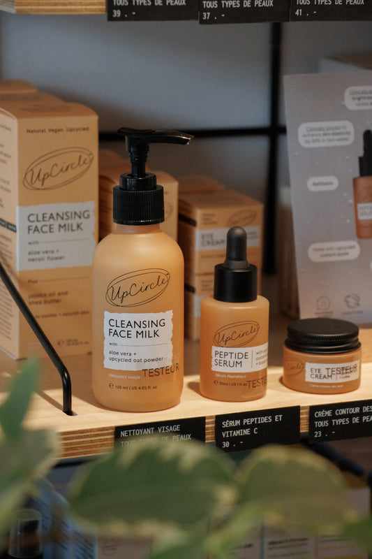 Upcircle skincare on a shop shelf surrounded by greenery 