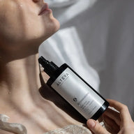 Woman holding a bottle of Alteva Bio Damascena Face Toner near her neck
