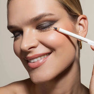 Model applying Uoga Uoga eye pencil to create smokey eye makeup look