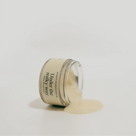 Jar of body scrub with 'Under the Milky Way' branding on a light gray background