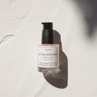 Skincare bottle labeled 'On the Wild Side' on a textured white background