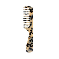 Tortoiseshell-patterned comb by Conscious Botanist on a white background