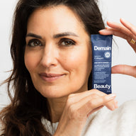 Sandra Gasmi, founder of Demain Beauty, holding an Age with Grace Augmented Collagen sachet beside her face against a plain background.