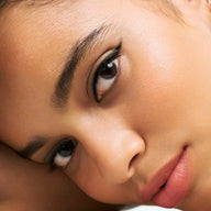 Close-up of woman's eye wearing Eclo black eyeliner pencil