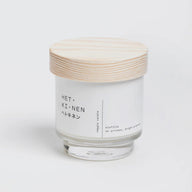 Hetkinen Biofilia Candle in a glass jar with a closed wooden lid on a white background