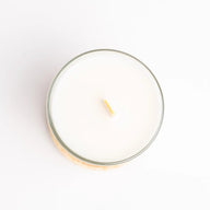 Hetkinen candle with a visible wood wick on a white background