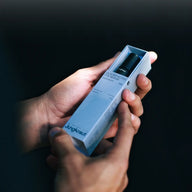 Hand holding a box with 'Jungkraut' branding against a dark background