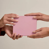 Two hands holding Lyfta Forehead and eyebrow kit against a beige background