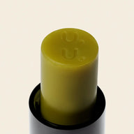 Close-up of Uoga Uoga Matchaberry green lip balm stick
