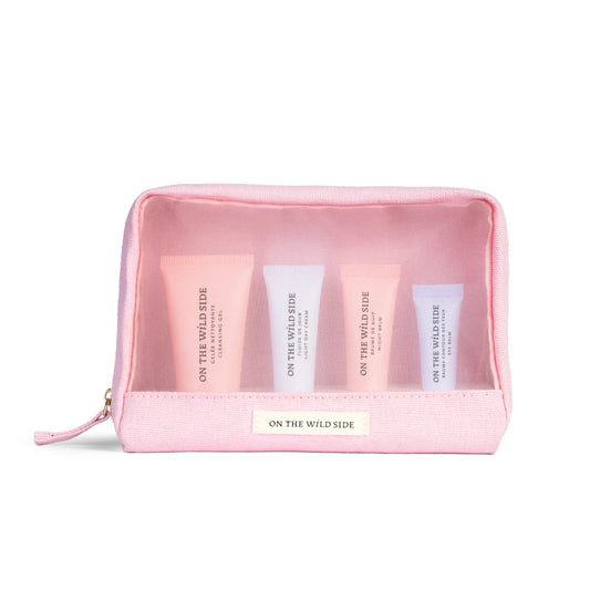 On the Wild Side Travel Discovery Set in a pink zipper beauty case displayed on a white background