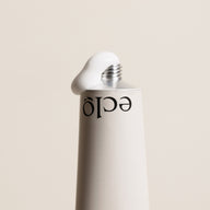 Eclo Regenerating Hand Balm metal tube with visible white cream coming out