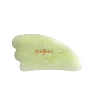 Green gua sha tool with 'Sentara' branding on a white background