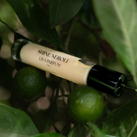 Shine Neroli Liya Parfum bottle on a green leafy background