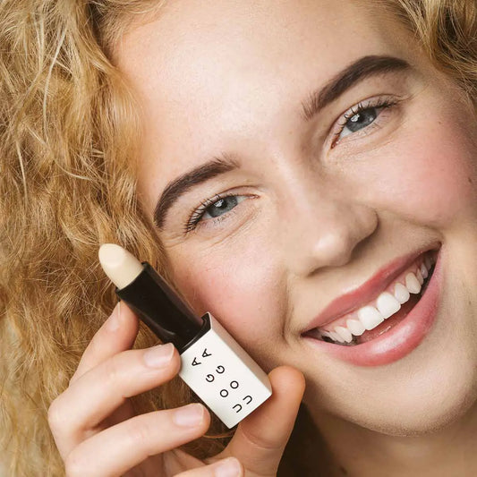 Woman holding Uoga Uoga Special Agent concealer in shade 002 