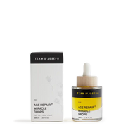 TEAM DR JOSEPH Age Repair Miracle Drops 30 ml face oil in a glass bottle with a wooden pipette cap, beside its black and white outer box