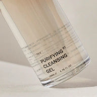 Close-up of the TEAM DR JOSEPH Purifying Cleansing Gel 200 ml bottle, showing the golden gel inside