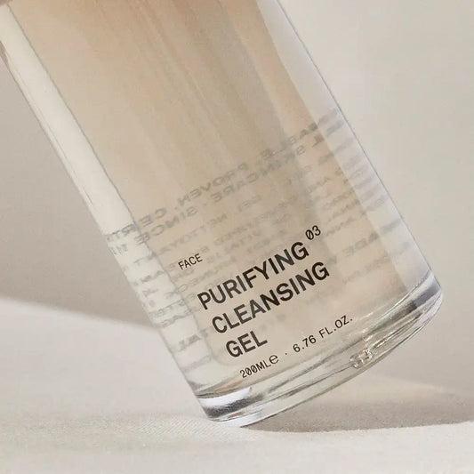 Close-up of the TEAM DR JOSEPH Purifying Cleansing Gel 200 ml bottle, showing the golden gel inside