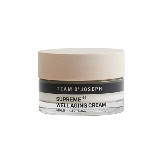 TEAM DR JOSEPH Supreme Well Aging Cream 50 ml in a clear glass jar with a light wooden lid, on a white background