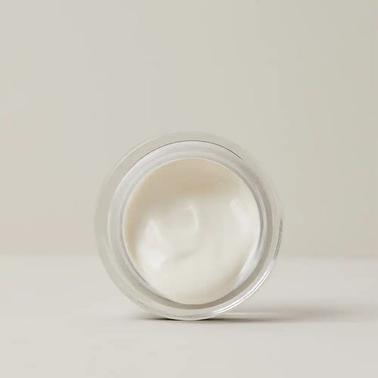 Top view of an open jar of TEAM DR JOSEPH Supreme Well Aging Cream showing its smooth white cream