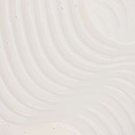Close-up of UpCircle Hair Serum highlighting its textured surface.