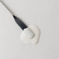 Macro view of Twelve Beauty Ideal Brightening Corrective Serum texture swatch on a metal spatula