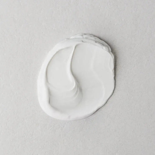 Twelve Beauty Artemisia Power Protection Moisturiser SPF50 creamy texture swatch on a gray background