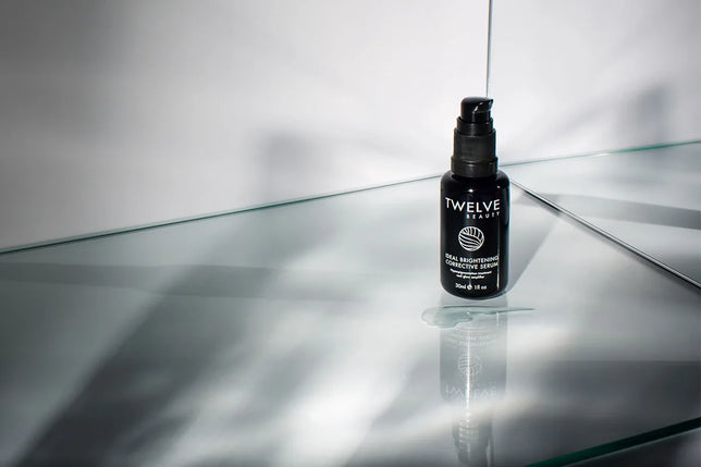 Twelve Beauty Ideal Brightening Corrective Serum on a reflective surface with a white background