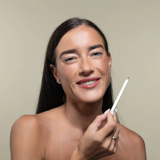 Woman with Uoga Uoga Cherry Wine lip pencil against a plain background