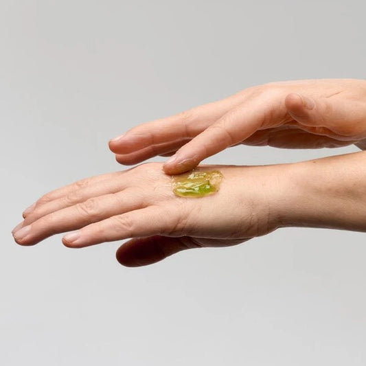 Bepure Calming Milk balm emulsifying into white cleansing milk between two hands.
