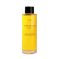 On The Wild Side Huile de soin Corps in a transparent glass bottle with a black cap displayed on white background