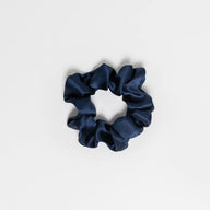 Hydra studio navy blue scrunchie on a light grey background