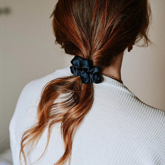 Hydra Studio navy blue satin scrunchie holding ponytail brown hair white sweater lifestyle shot