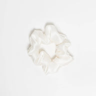 Hydra Studio white scrunchie on a light beige background